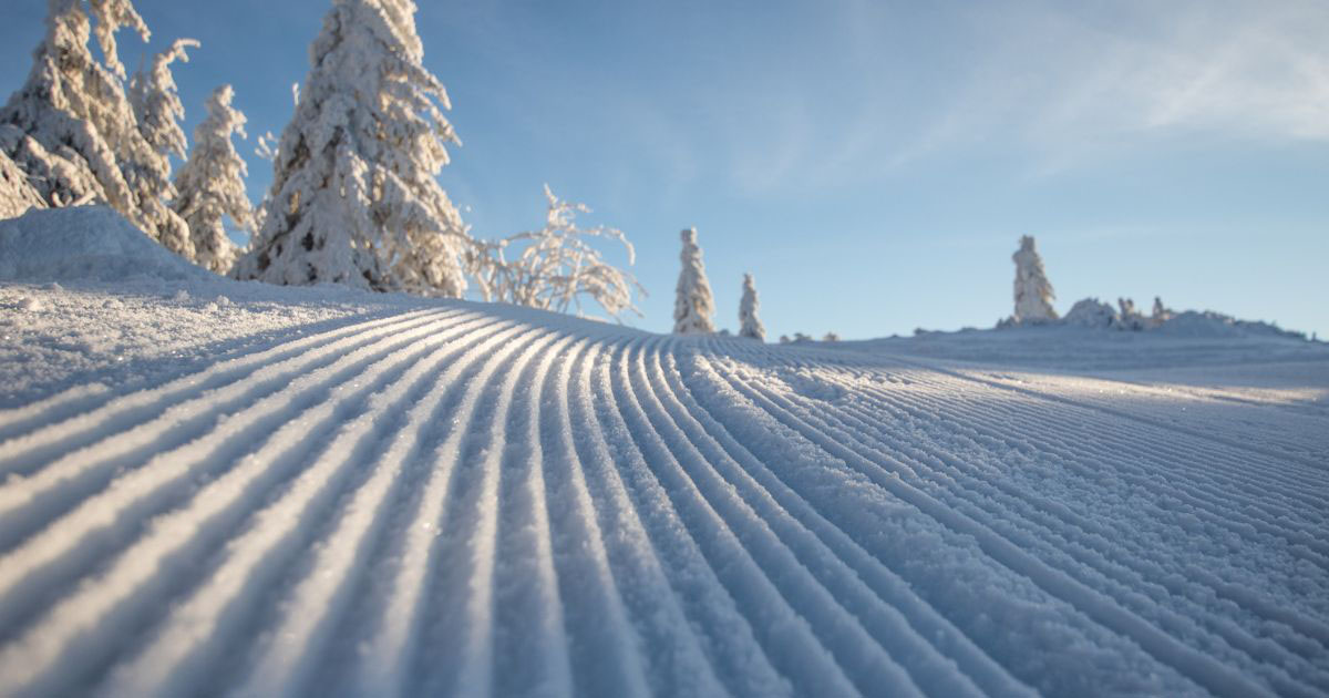 Freshly groomed ski slope with corduroy snow at winter resort