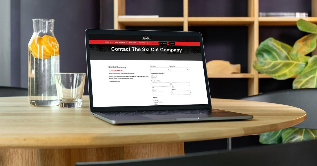 Ski Cat Company snowcat rental contact page on laptop